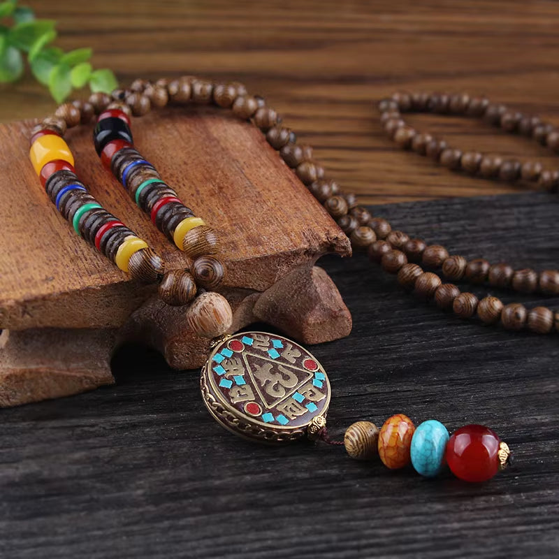 Necklace with colorful beads and a decorative pendant on a wooden surface