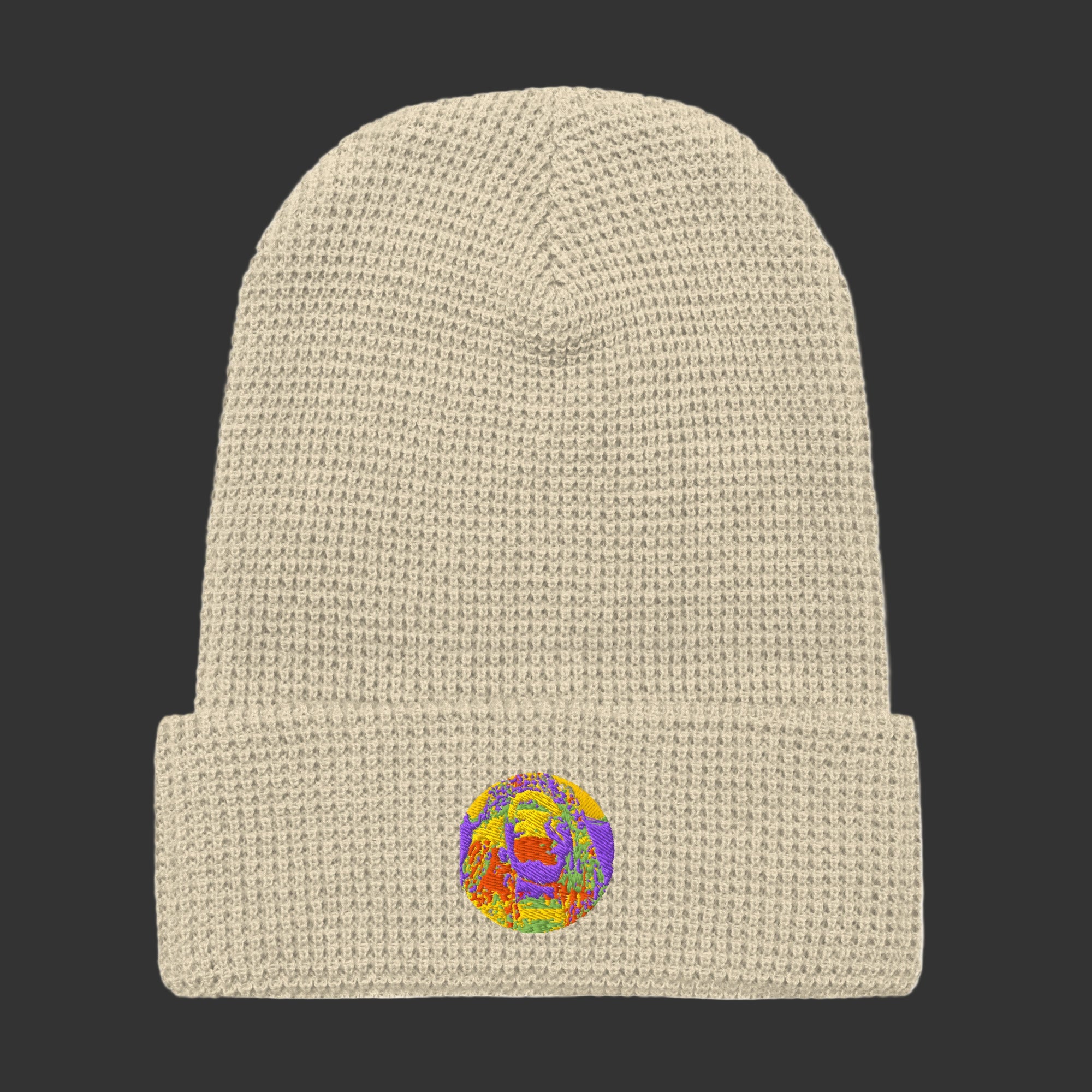 Beige knit beanie with a colorful embroidered logo on a white background